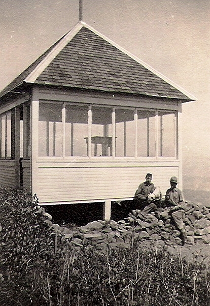 BenLomond lookout, This photo shows Butte Williams (with bulldog) and Jim Bader at the lookout in 1915, the year it was built. Williams was the first lookout. Note the firefinder inside the building.